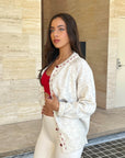Cream cardigan with red stitching
