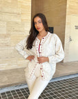 Cream cardigan with red stitching