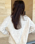 Cream cardigan with red stitching