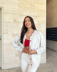 Cream cardigan with red stitching