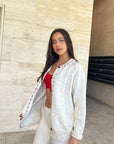 Cream cardigan with red stitching