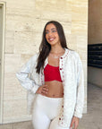 Cream cardigan with red stitching