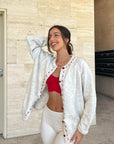 Cream cardigan with red stitching