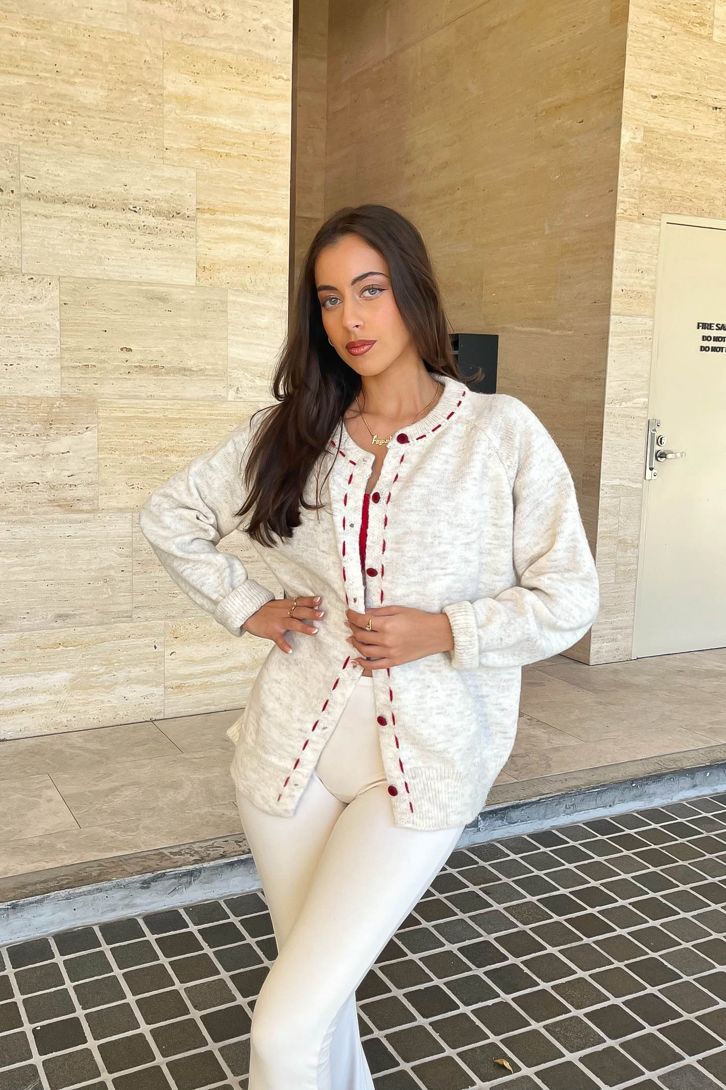 Cream cardigan with red stitching