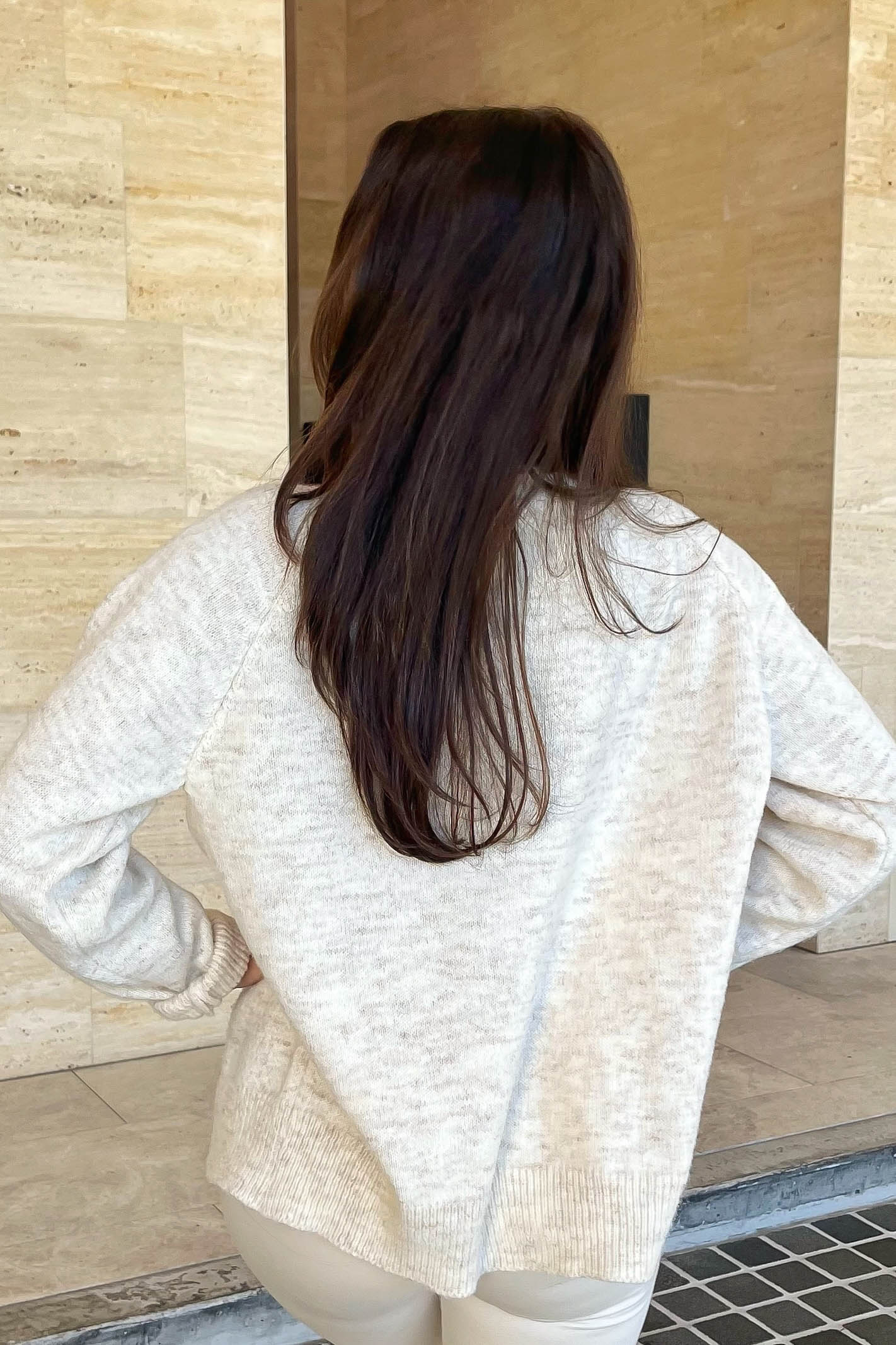 Cream cardigan with red stitching