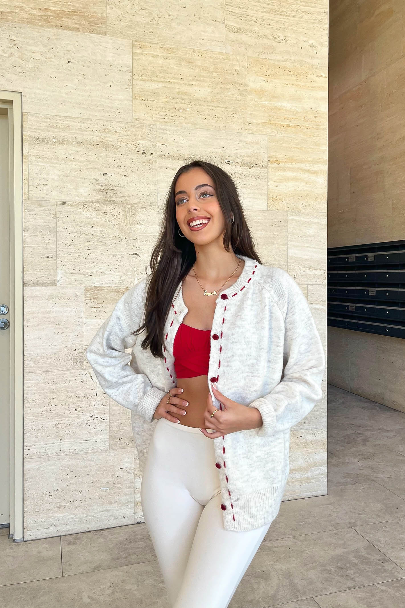 Cream cardigan with red stitching