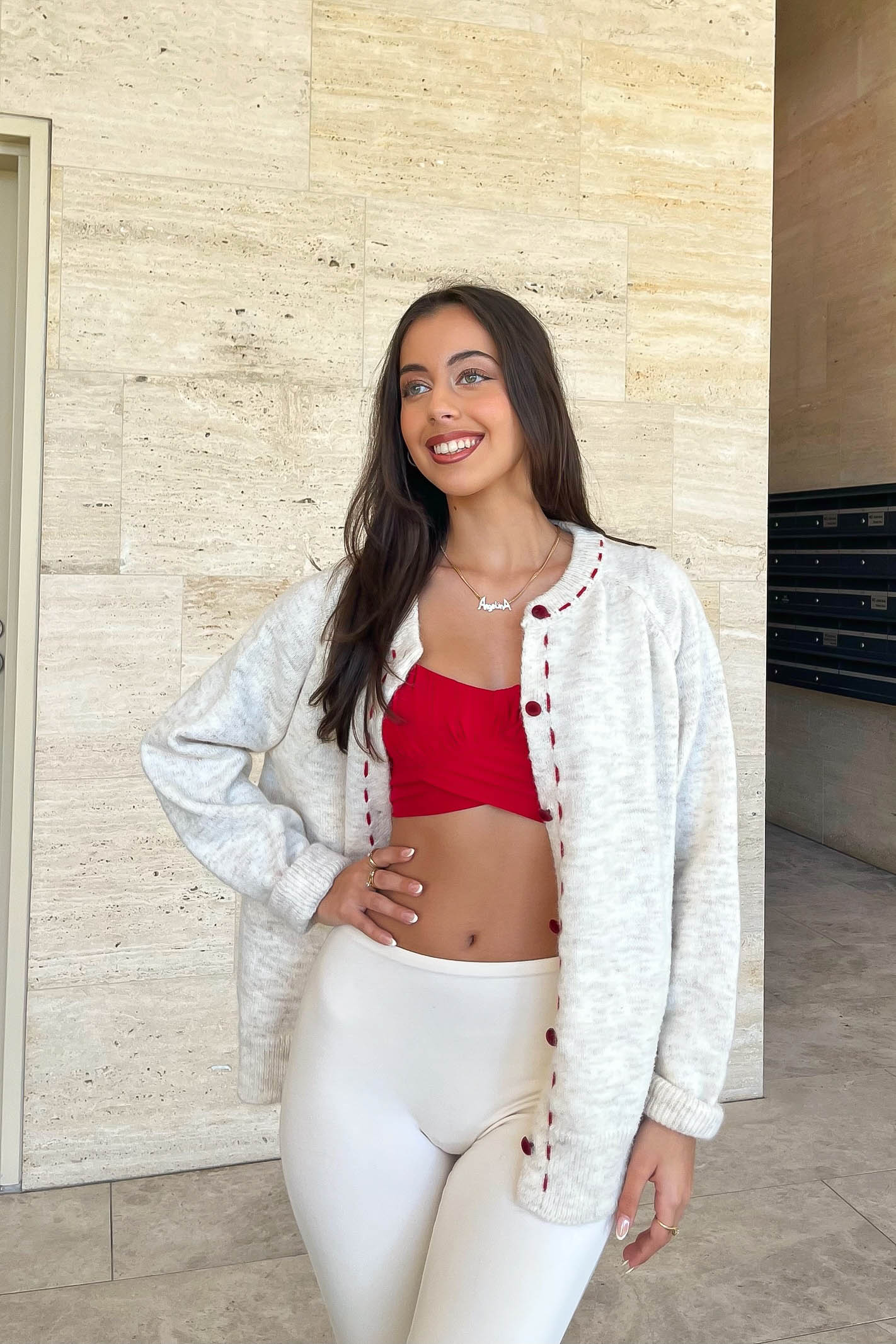 Cream cardigan with red stitching
